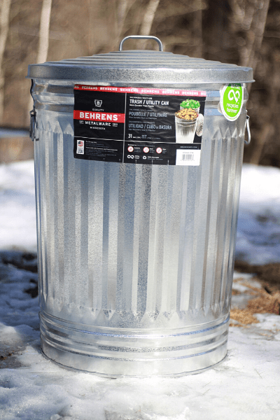 New 30 Gal Metal Trash Can sitting outside on the icy ground