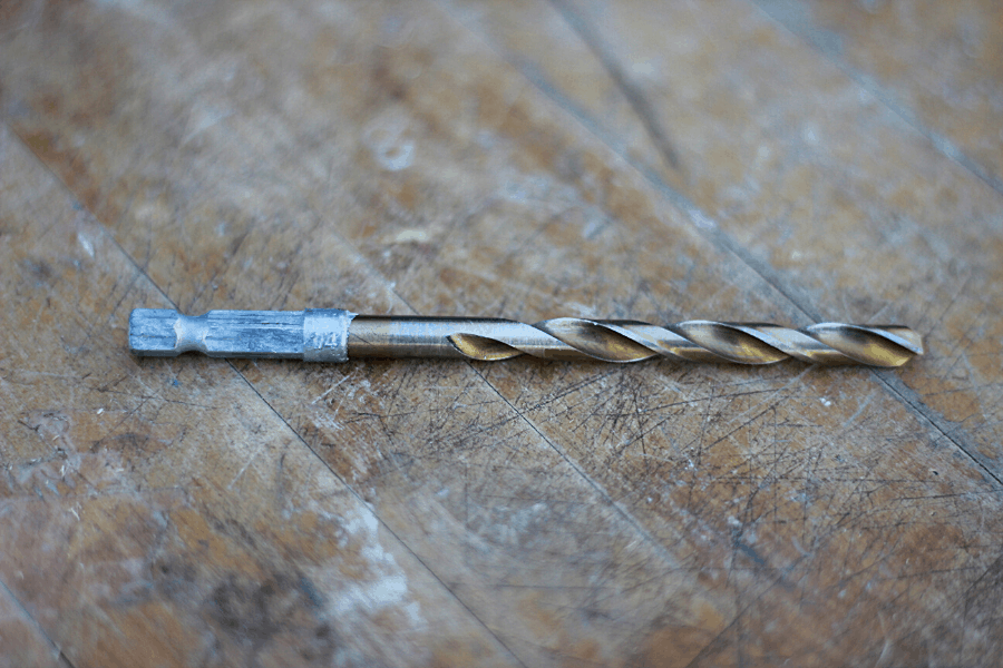 1/4'' drill bit laying on a wooden table