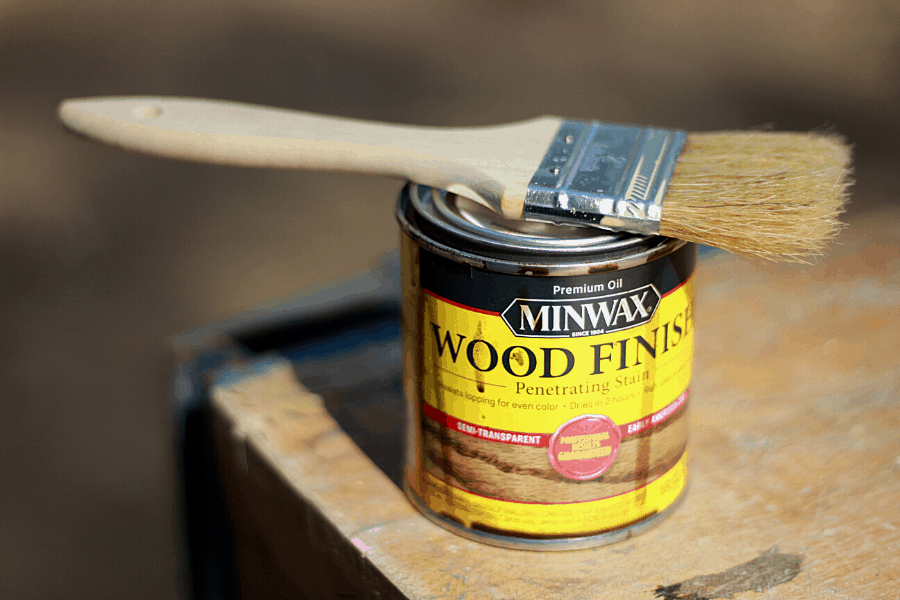 Minwax wood finish with chip brush sitting on top of can