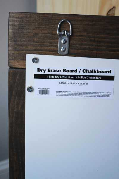 Back of DIY chalkboard showing screws and d-ring