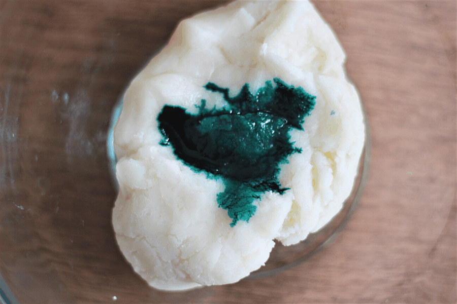 Homemade playdough with edible food coloring dropped on top
