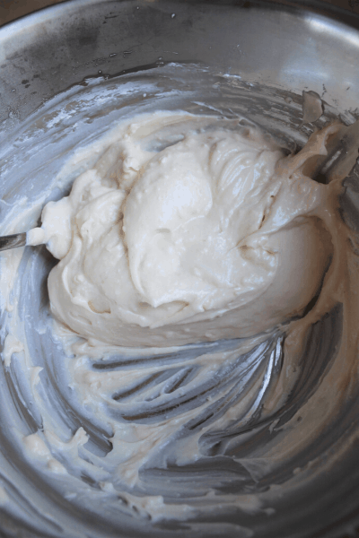 cream cheese frosting from scratch in a metal bowl