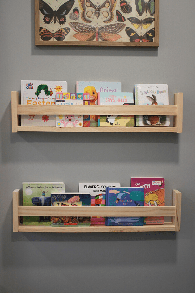 Two diy ikea children's bookshelf hanging on the wall with books displayed
