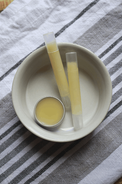 three containers of diy chapstick in a small ceramic bowl