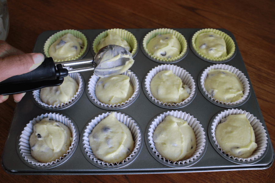 chocolate chip muffin batter evenly divided into 12 lined muffin tins 