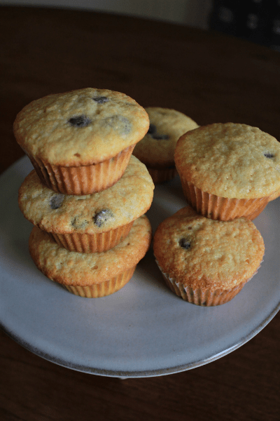 chocolate chip muffins stacked on top of each other on a cake stand
