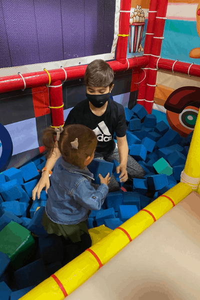 two kids in a foam pit at a trampoline park