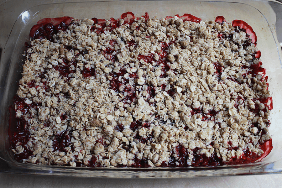 homemade strawberry & blueberry crisp in a 9x13 glass baking dish