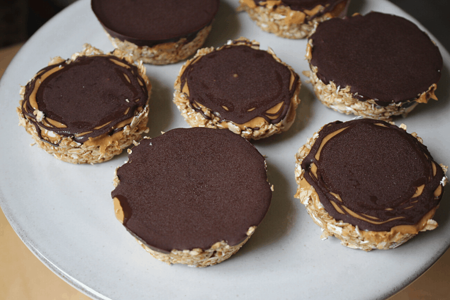 no bake oat cups with cashew butter and dark chocolate spread out on a cake stand
