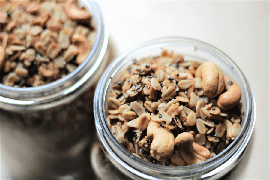 two mason jars filled with easy granola recipe with cashews and chia seeds
